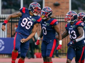 Alouettes Jamal Davis, left, celebrates a sack against the Redblacks last season. In only nine games, Davis had 17 tackles and four sacks. He also recovered a fumble, returning it 19 yards for a touchdown.