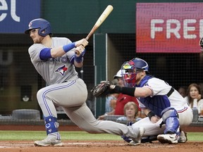 Blue Jays catcher Danny Jansen follows thru on a single during the first inning against the Texas Rangers at Globe Life Field. Jansen went 4-for-5 with a homer and three RBIs in the Jays' 11-7 win.