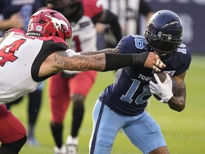 Argonauts wide receiver Brandon Banks (right) tries to break a tackle against Stampeders linebacker Cameron Judge (left) during first half CFL action at BMO Field in Toronto, Aug. 20, 2022.