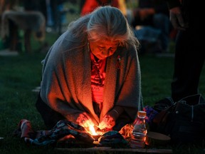 A woman prepares for sunrise ceremony, attended by Prime Minister Justin Trudeau to mark the National Day for Truth and Reconciliation, honouring the lost children and survivors of Indigenous residential schools, at Niagara Parks power station in Niagara Falls, Ont., Sept. 30, 2022.