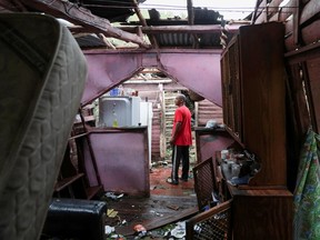 A man stands inside his destroyed house in the rural zone of Cuey, in the aftermath of Hurricane Fiona, in El Seibo, Dominican Republic, September 20, 2022.