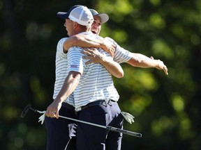 Justin Thomas (R) of the United States Team and Jordan Spieth (L) of the United States Team celebrate winning 2&1 over Adam Scott of Australia and Cam Davis of Australia and the International Team during Friday four-ball matches on day two of the 2022 Presidents Cup at Quail Hollow Country Club in Charlotte, N.C.
