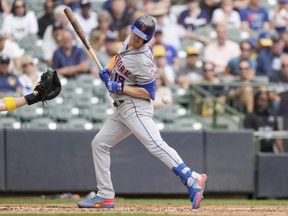 Mets batter Mark Canha is hit by a pitch by Adrian Houser of the Brewers in the fifth inning during MLB action at American Family Field in Milwaukee, Wednesday, Sept. 21, 2022.
