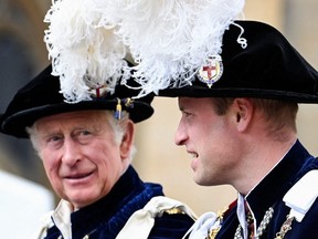 Britain's Prince Charles, Prince of Wales (left) and Britain's Prince William, Duke of Cambridge leaves in a horse-drawn carriage from St George's Chapel after attending the Most Noble Order of the Garter Ceremony at Windsor Castle in Windsor, west of London, June 13, 2022.
