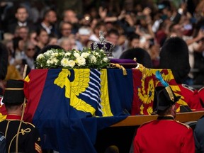 The coffin containing Queen Elizabeth II is carried in a ceremonial procession from Buckingham Palace to the Palace of Westminster in London, Wednesday, Sept. 14, 2022.