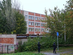 Police officers secure the area near a school after a gunman opened fire there, in Izhevsk, Russia September 26, 2022.