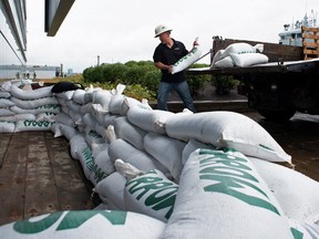 Francis Bruhm, project manager for general contractor G&R Kelly, places sandbags around the doors of the Nova Scotia Power building before the arrival of Hurricane Fiona in Halifax, Sept. 23, 2022.