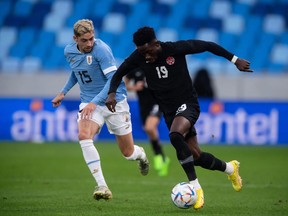 Uruguay's midfielder Federico Valverde (L) and Canada's defender Alphonso Davies vie for the ball during the friendly football match between Canada and Uruguay in Bratislava, Slovakia on September 27, 2022.
