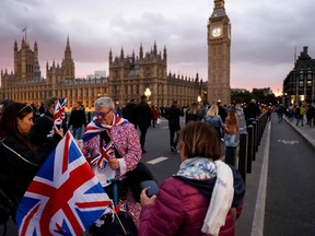 A street vendor sells Union Jack flags to well-wishers on Westminster Bridge in London on September 18, 2022, following the death of Queen Elizabeth II on Sept. 8.