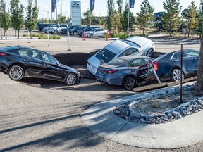 Four cars parked in front of Infinity south Edmonton fell into a sinkhole that developed on September 20, 2022. No one from the dealership was willing to talk about the damage to the cars parked in the visitor parking stalls.