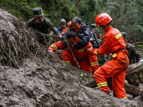 This photo taken on September 8, 2022 shows paramilitary police officers and rescuers evacuating residents following a 6.6-magnitude earthquake on September 5.