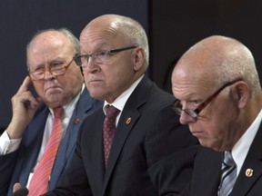 Senator Daniel Lang (centre), Senator Colin Kenny and Senator Jean-Guy Dagenais listen to a question during a press conference in Ottawa, April 13, 2017. Quebec senator Jean-Guy Dagenais says Pierre Poilievre's first week as new Conservative leader has left him "comfortable" with his decision to leave the party.