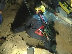 A screen grab from video shows a blind dog being rescued from a hole in Pasadena, Calif.