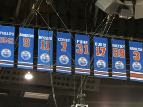 Banners of retired Oilers numbers are seen in the rafters.