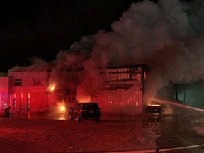 Fire crews battle a Dec. 30, 2019, blaze at a Honda dealership in Edson. The blaze was one of five alleged arsons to occur in western Alberta towns in late 2019 and early 2020.