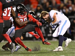 Argonauts running back A.J. Ouellette loses his helmet, but Redblacks linebacker Frankie Griffin earns a major penalty for facemasking.