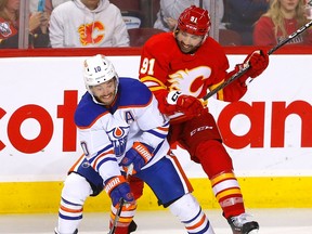 Calgary Flames forward Nazem Kadri battles Edmonton Oilers forward Derek Ryan at the Scotiabank Saddledome in Calgary on Wednesday, Sept. 28, 2022.