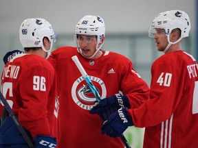 New Vancouver Canuck Ilya Mikheyev (centre) talks to his new Russian linemate Andrey Kuzmenko while Elias Pettersson (right) waits to get a word in during the first day of Vancouver Canucks training camp in Whistler on Sept. 22, 2022.