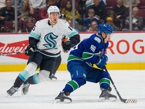 Vancouver Canucks forward Andrei Kuzmenko (96) moves the puck against the Seattle Kraken in the first period at Rogers Arena.