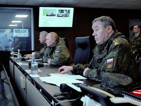 Russian President Vladimir Putin, centre, accompanied by Defence Minister Sergei Shoigu, left, and Valery Gerasimov, the chief of the Russian General Staff, oversees the 'Vostok-2022' military exercises at the Sergeevskyi training ground outside the city of Ussuriysk on the Russian Far East on Sept. 6, 2022.