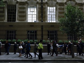 Members of the public stand in the queue in the evening for the Lying-in State of Queen Elizabeth II on September 16, 2022 in London.