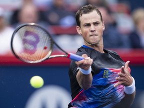 CanadaÕs Vasek Pospisil returns to Tommy Paul of the United States during first round action at the National Bank Open tennis tournament Tuesday August 9, 2022 in Montreal.