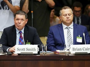 Witnesses Scott Smith, Hockey Canada President and Chief Operating Officer, left, and Hockey Canada Chief Financial Officer Brian Cairo, appear at the standing committee on Canadian Heritage in Ottawa on Wednesday, July 27, 2022, looking into how Hockey Canada handled allegations of sexual assault and a subsequent lawsuit.
