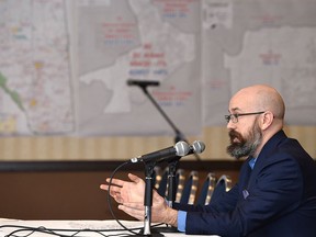 Duncan Kinney, executive director of Progress Alberta, speaks at an Alberta Electoral Boundaries Commission hearing in 2017. Kinney is currently charged with mischief for allegedly spray painting a statue he later wrote about.