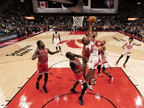 Toronto Raptors forward Justin Champagnie (11) battles for a rebound with Chicago Bulls forward Javonte Green.