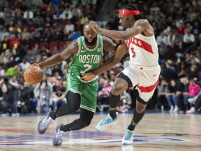 Boston Celtics’ Jaylen Brown gets by Toronto Raptors’ Precious Achiuwa.
