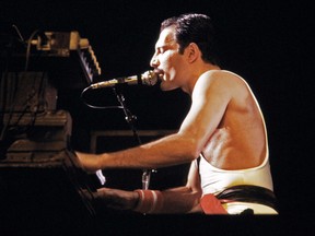 In this file photo taken on September 18, 1984 rock star Freddie Mercury, lead singer of the rock group "Queen," performs during a concert at the Palais Omnisports de Paris Bercy (POPB).