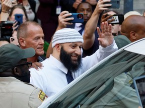 Adnan Syed, whose case was chronicled in the hit podcast Serial, smiles and waves as he heads to a vehicle after exiting the courthouse in Baltimore, Maryland September 19, 2022.