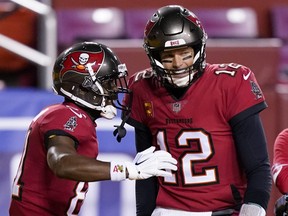 Tampa Bay Buccaneers wide receiver Antonio Brown (81) celebrates his touchdown with teammate quarterback Tom Brady (12) during the first half of an NFL wild-card playoff football game against the Washington Football Team, Saturday, Jan. 9, 2021, in Landover, Md.