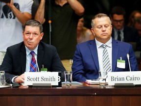 Scott Smith, Hockey Canada president and chief operating officer, left, and Hockey Canada chief financial officer Brian Cairo testify before the standing committee on Canadian Heritage, in Ottawa on July 27.