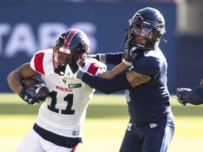 Montreal Alouettes receiver Kaion Julien-Grant (11) fights off Toronto Argonauts defensive-back Royce Metchie (9) during first half CFL football action in Toronto on Saturday, Oct. 29, 2022.