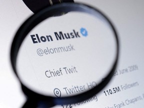 Elon Musk's Twitter account is seen through a magnifier in this photo illustration taken Oct. 28, 2022.