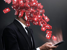 Love Social Media Post Addiction Concept. Businessman Open Phone Love Icons Pop Up to The Face.