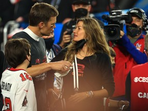 Tom Brady #12 of the Tampa Bay Buccaneers celebrates with Gisele Bundchen after winning Super Bowl LV at Raymond James Stadium on February 07, 2021 in Tampa, Florida. (Photo by Mike Ehrmann/Getty Images)
