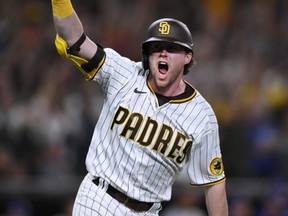Padres second baseman Jake Cronenworth celebrates after a two-RBI double in the seventh inning against the Dodgers during Game 4 of the NLDS at Petco Park in San Diego, Saturday, Oct. 15, 2022.