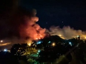 Dieser Bildausschnitt aus einem UGC-Video, das am Samstag, den 15. Oktober 2022 zur Verfügung gestellt wurde, zeigt Berichten zufolge Flammen und dicken Rauch, die aus dem Evin-Gefängnis im Nordwesten der iranischen Hauptstadt Teheran aufsteigen.