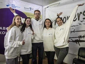 Staff members of the Centre for Civil Liberty pose for a photo and celebrate in their office after receiving the 2022 Nobel Peace Prize, along with human rights advocate Ales Bialiatski from Belarus, and the Russian human rights organization Memorial, on Friday, Oct. 7, 2022 in Kyiv, Ukraine.