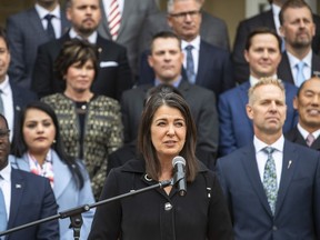 Alberta Premier Danielle Smith, along with cabinet ministers, speaks at a press conference after members were sworn into cabinet in Edmonton, Monday, Oct. 24, 2022. Smith says she is cancelling a health consulting agreement involving the World Economic Forum because she doesn't want to have any ties with a group that brags about controlling world governments and politicians.