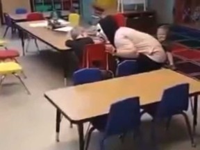 In this screengrab a video posted on Facebook, a day care worker is pictured scaring with a child.