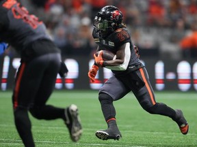 B.C. Lions' James Butler (24) carries the ball and scores a touchdown against the Winnipeg Blue Bombers during the first half of CFL football game in Vancouver, on Saturday, October 15, 2022.