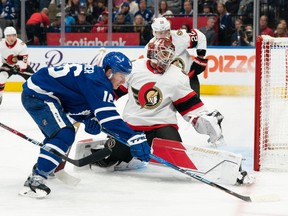 Ottawa Senators goaltender Cam Talbot (33) battles for the puck with Toronto Maple Leafs right wing Mitchell Marner (16) during the first period at Scotiabank Arena, Sept. 24, 2022.
