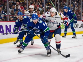 Vancouver Canucks forward J.T. Miller, left, battles with Washington Capitals forward T.J. Oshie at Rogers Arena.