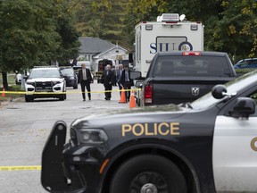 Police and SIU investigators gather at the scene where two police officers were killed in Innisfil, Ont., on Wednesday, Oct. 12, 2022.