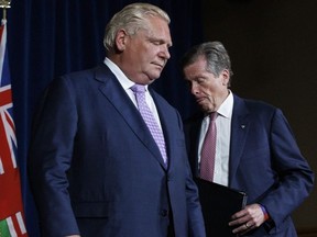 Ontario Premier Doug Ford and Toronto Mayor John Tory, shuffle during a joint press conference inside Queen's Park in Toronto, Monday, June 27, 2022.