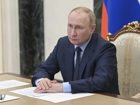 Russian President Vladimir Putin attends a meeting via teleconference call, in Moscow, Russia, Monday, Aug. 22, 2022.