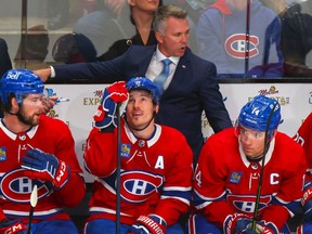 Montreal Canadiens head coach Martin St. Louis speaks to, from left, Josh Anderson, Brendan Gallagher and Nick Suzuki during third period against the Pittsburgh Penguins in Montreal on Oct. 17, 2022.